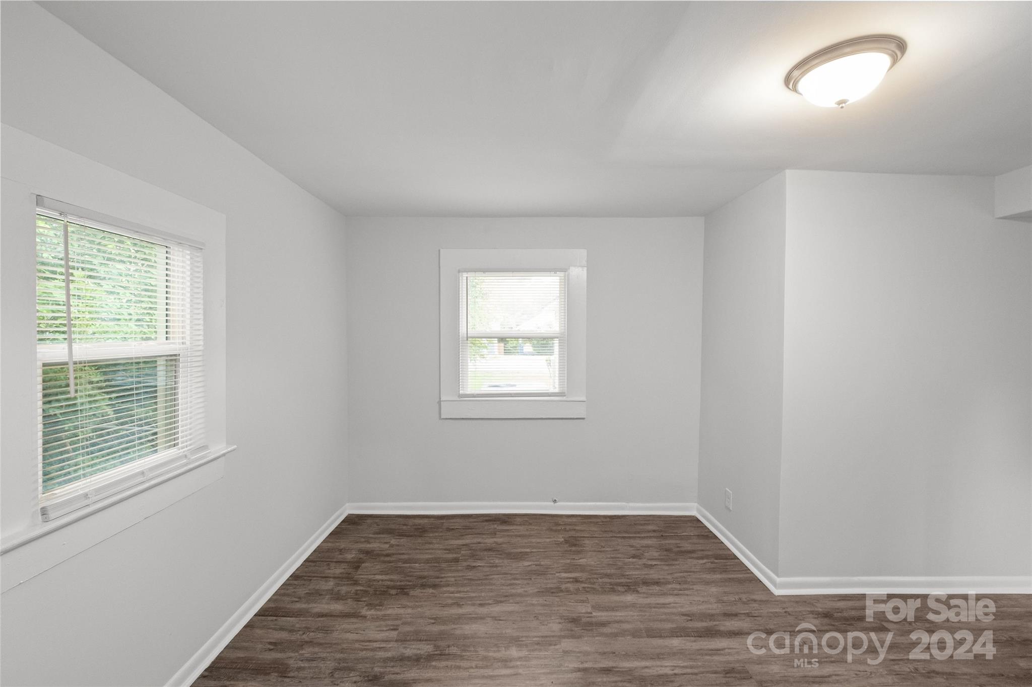 3106 Tuckaseegee Road Charlotte, NC 28208 - Photo 24 of 44 an empty room with wooden floor and windows