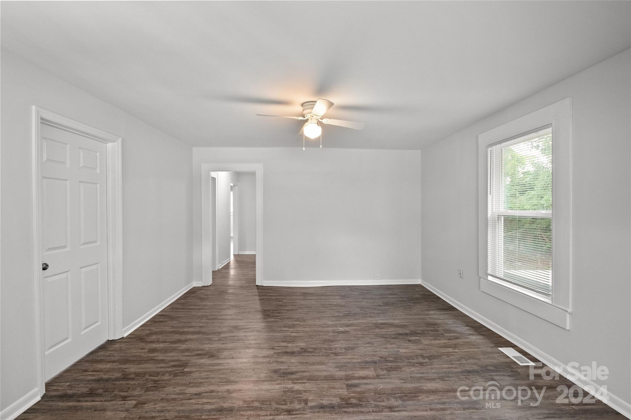 3106 Tuckaseegee Road Charlotte, NC 28208 - Photo 7 of 44 wooden floor in an empty room with a window