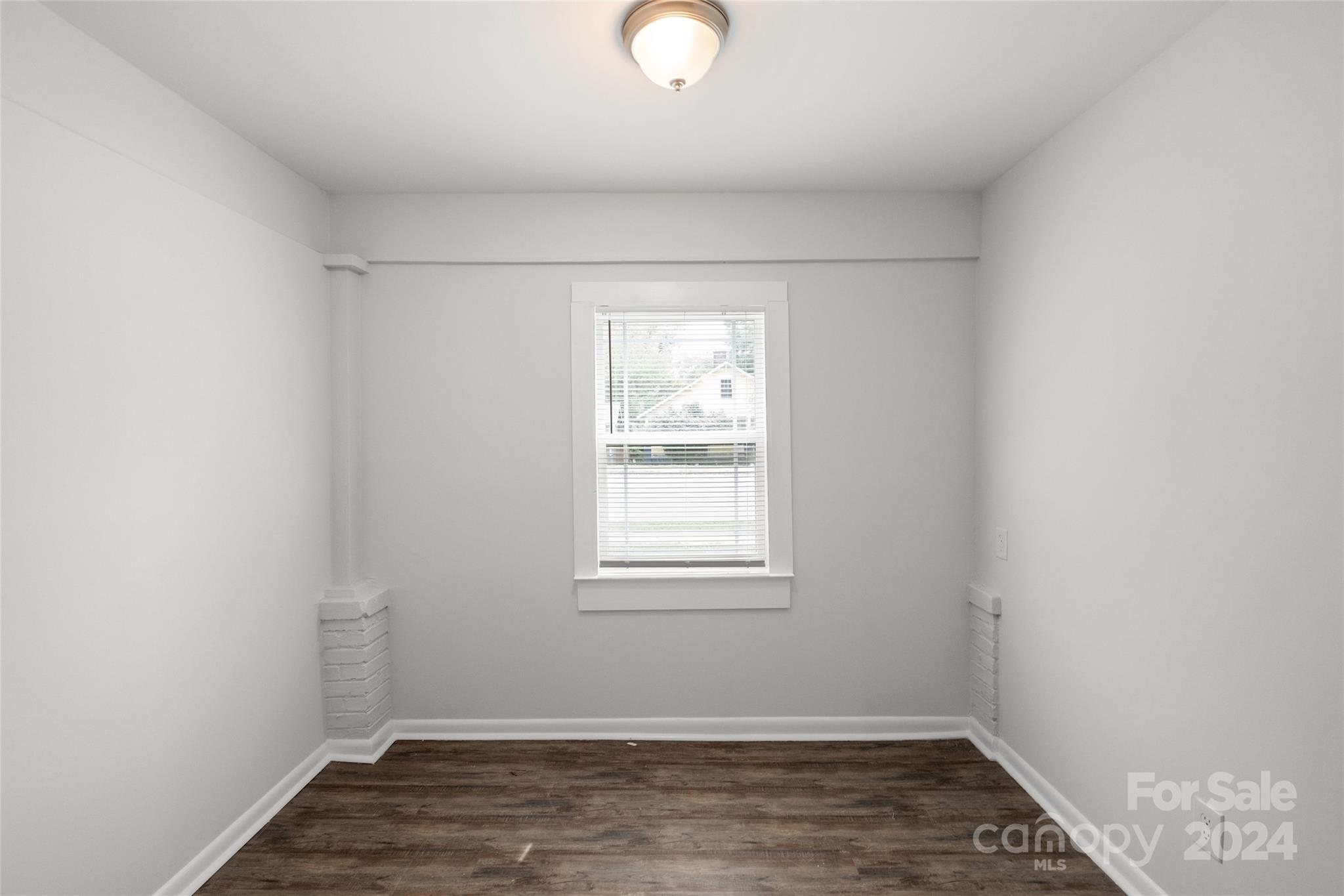 3106 Tuckaseegee Road Charlotte, NC 28208 - Photo 8 of 44 an empty room with wooden floor and windows