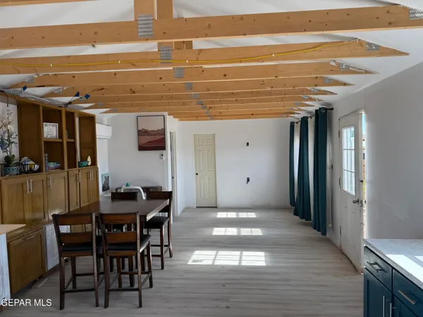 a view of room with window and wooden floor