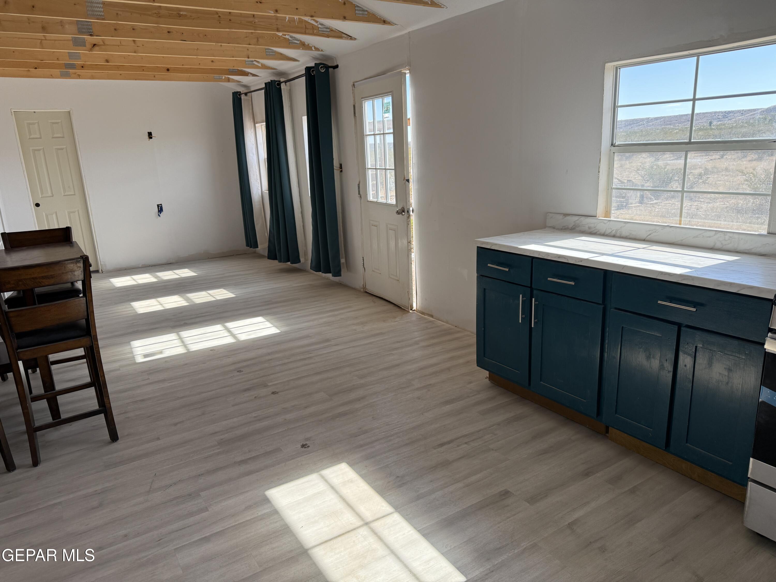 26 Ponderosa Road Salt Flat, TX 79847 - Photo 26 of 56 an empty room with wooden floor and windows