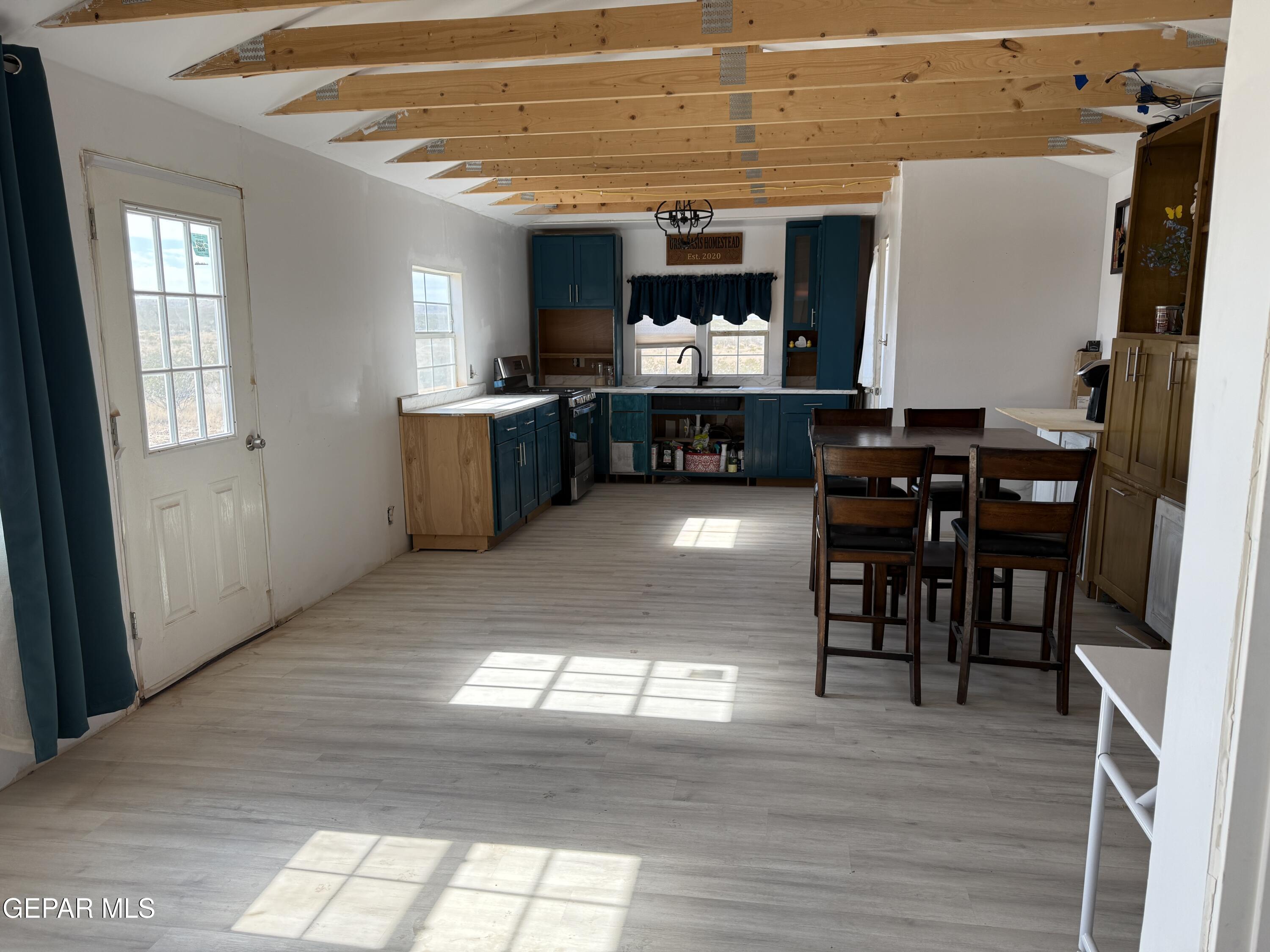 26 Ponderosa Road Salt Flat, TX 79847 - Photo 28 of 56 a kitchen with stainless steel appliances kitchen island granite countertop a table chairs and a refrigerator