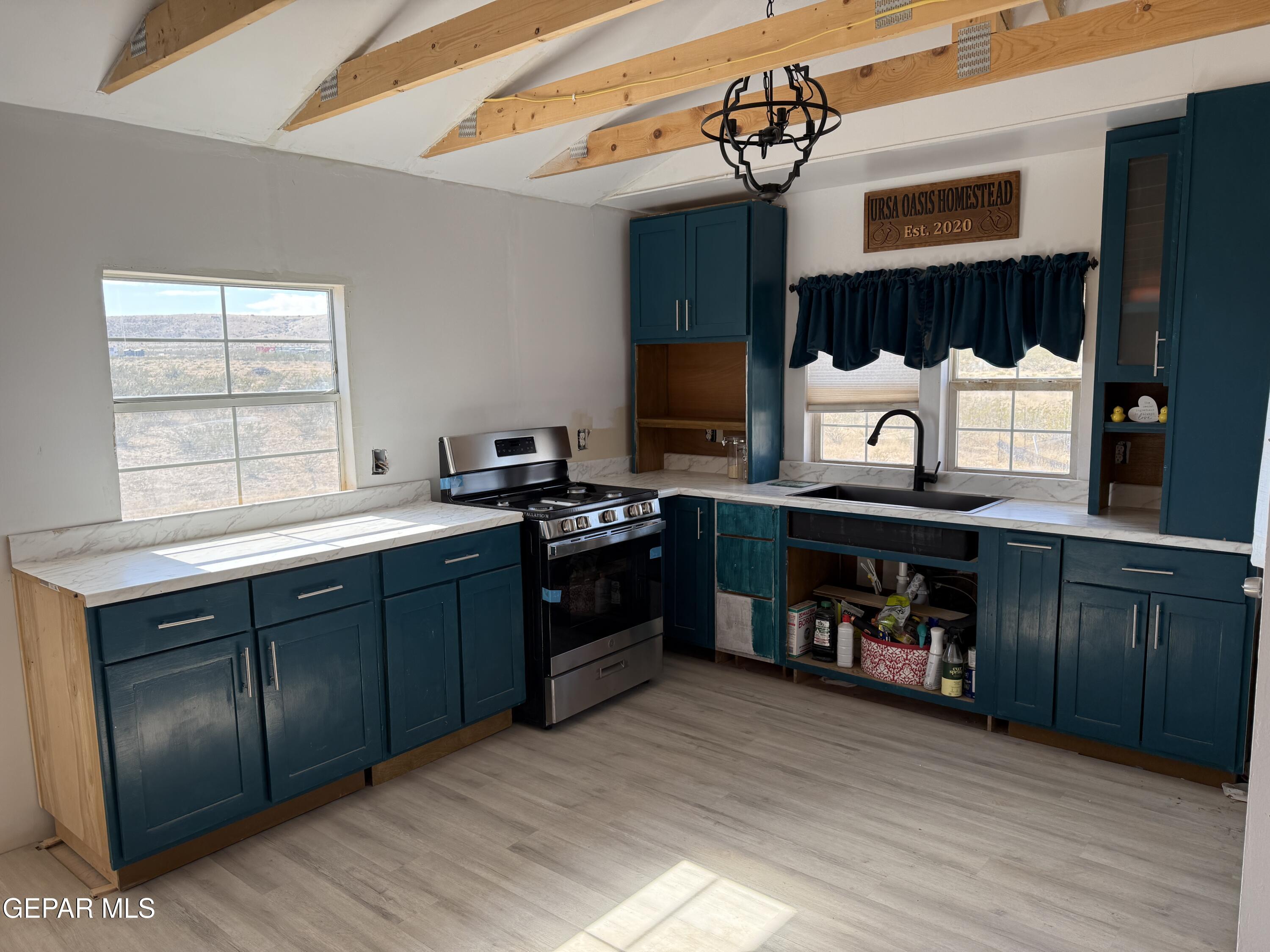 26 Ponderosa Road Salt Flat, TX 79847 - Photo 31 of 56 a kitchen with stainless steel appliances granite countertop a sink and wooden cabinets