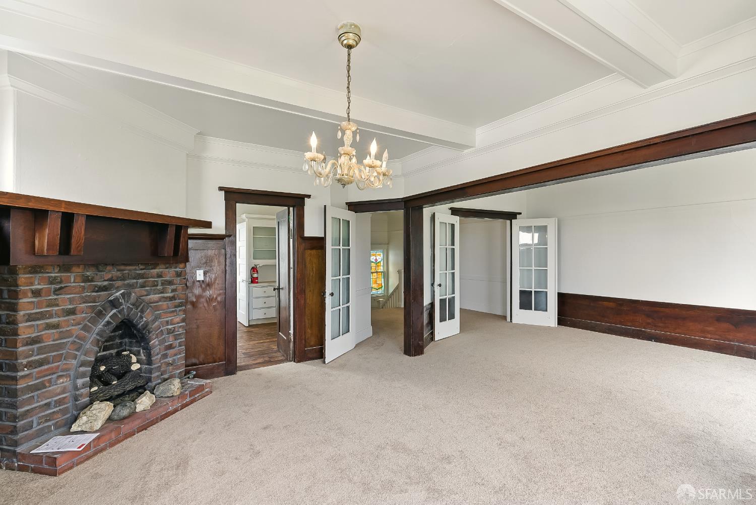 425-429 Steiner Street San Francisco, CA 94117 - Photo 24 of 40 a view of a livingroom with a fireplace a chandelier and windows