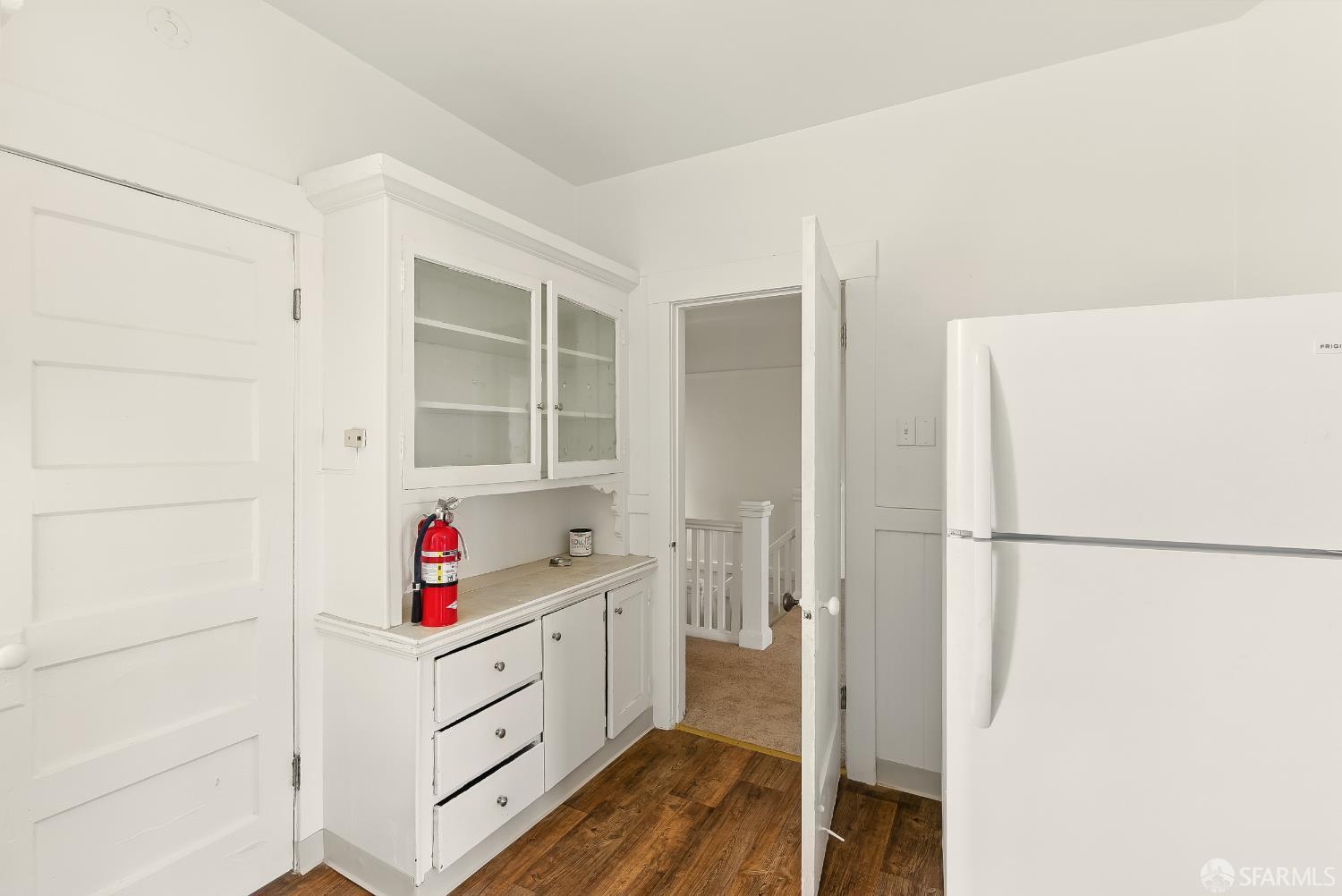 425-429 Steiner Street San Francisco, CA 94117 - Photo 27 of 40 a kitchen with white cabinets and white appliances