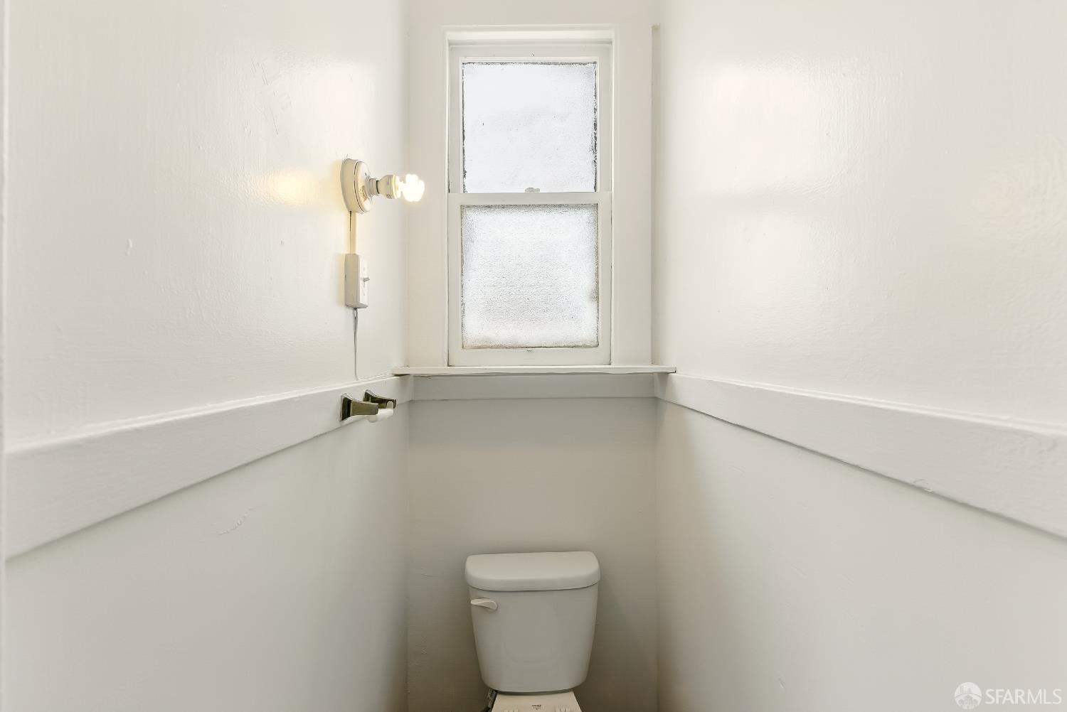 425-429 Steiner Street San Francisco, CA 94117 - Photo 29 of 40 a bathroom with a toilet sink and window