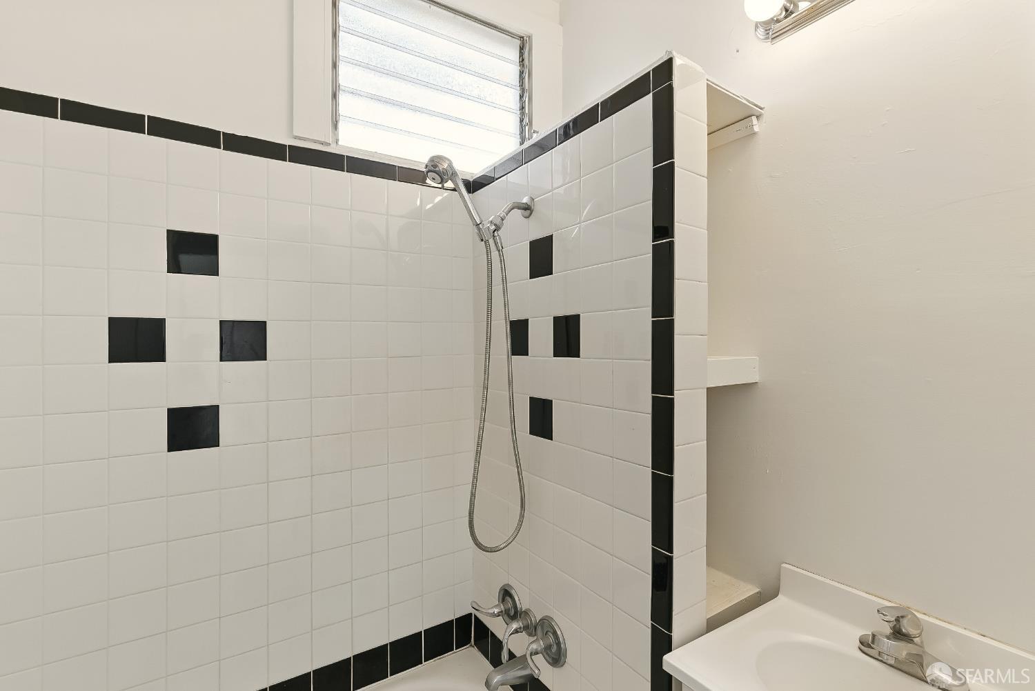 425-429 Steiner Street San Francisco, CA 94117 - Photo 30 of 40 a bathroom with a shower and mirror