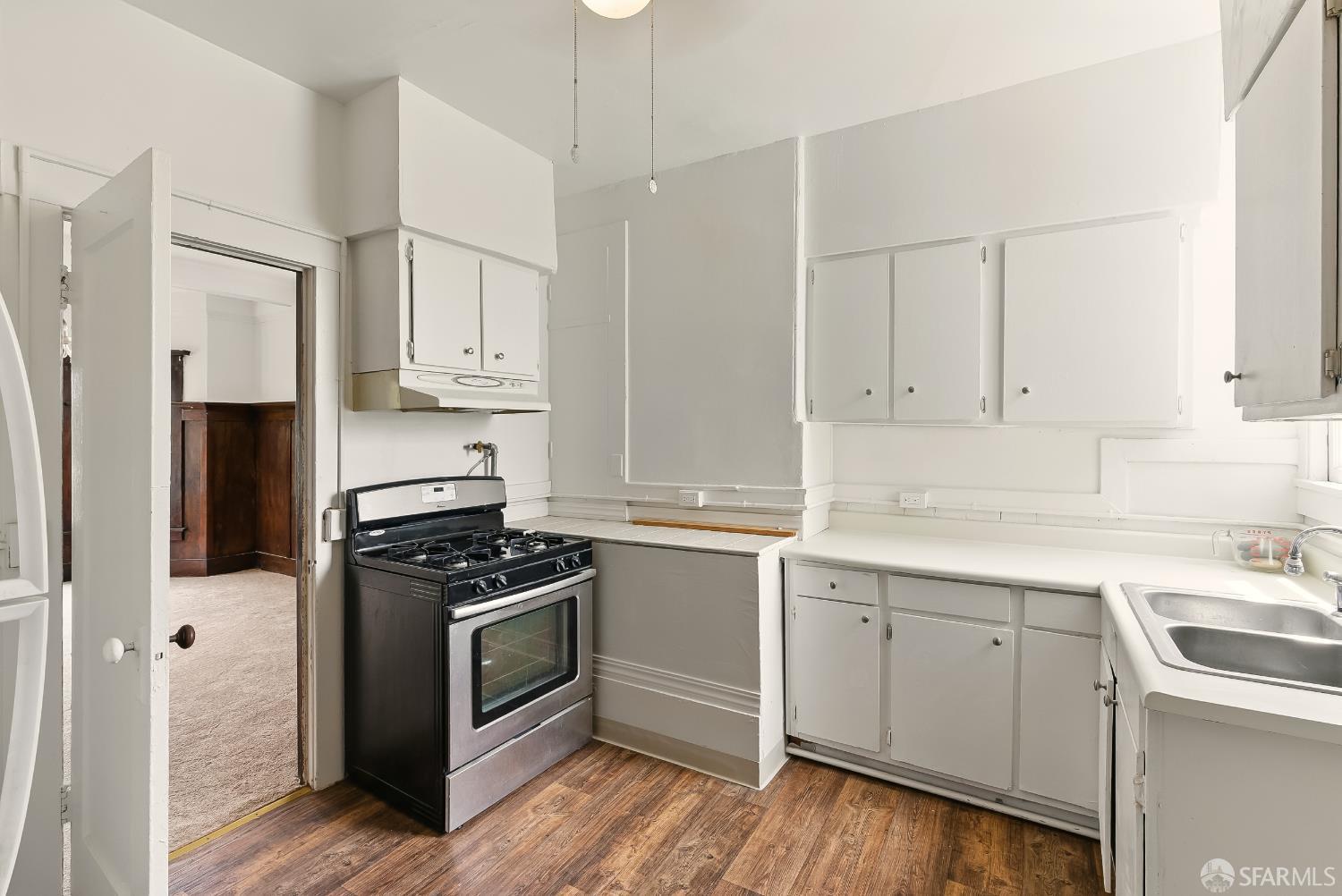 425-429 Steiner Street San Francisco, CA 94117 - Photo 9 of 40 a kitchen with cabinets appliances a sink and a counter top space