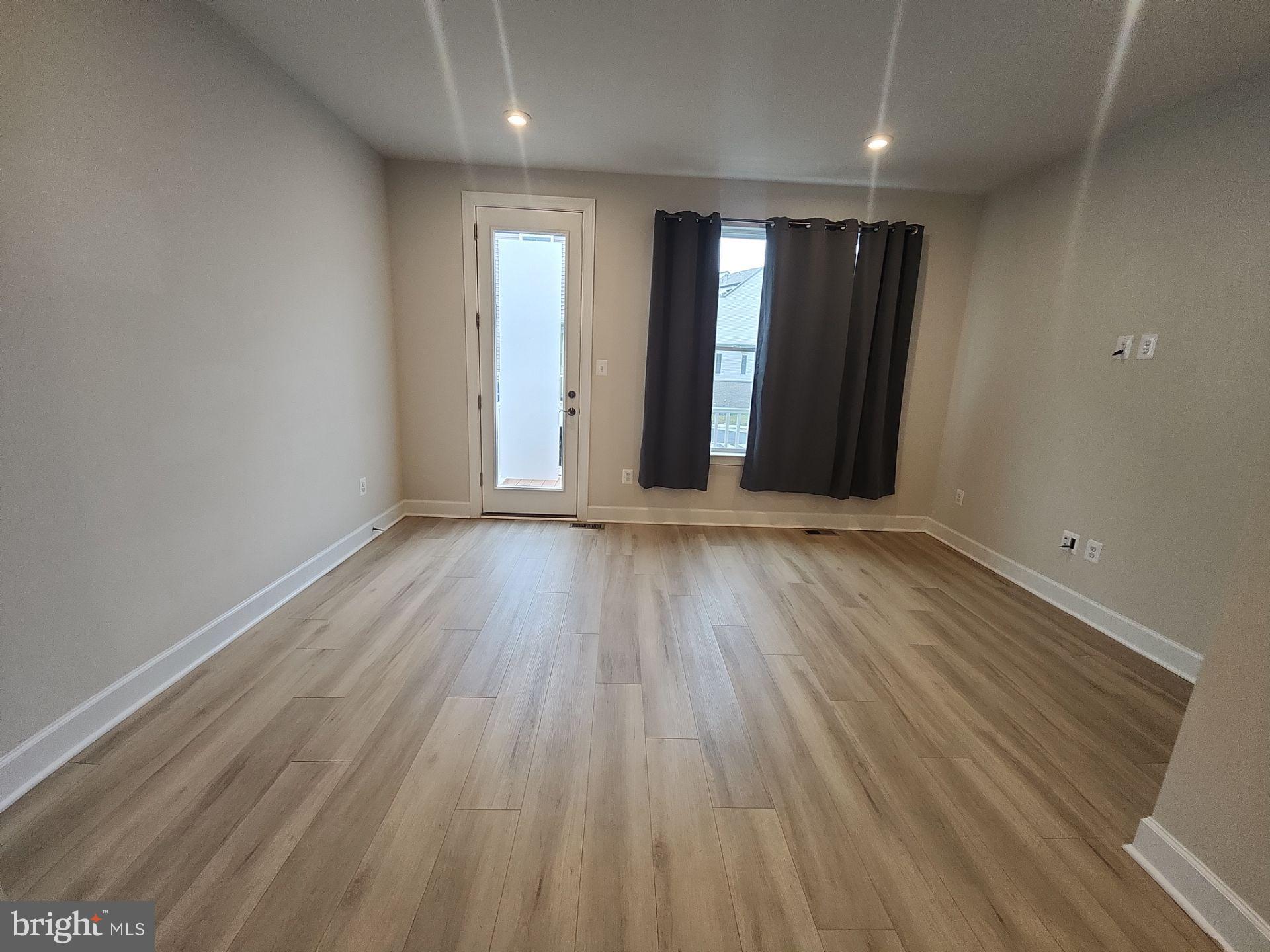 6730 Belcrest Road Hyattsville, MD 20782 - Photo 11 of 30 an empty room with wooden floor and windows
