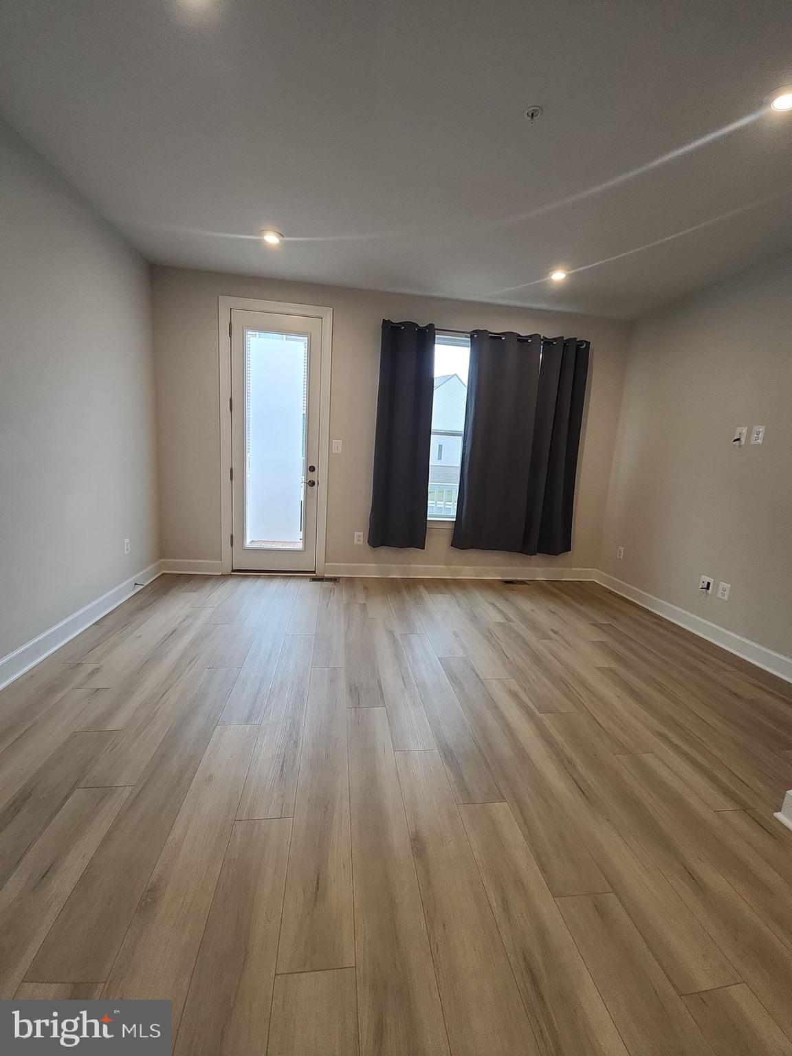 6730 Belcrest Road Hyattsville, MD 20782 - Photo 12 of 30 a view of an empty room with wooden floor and a window