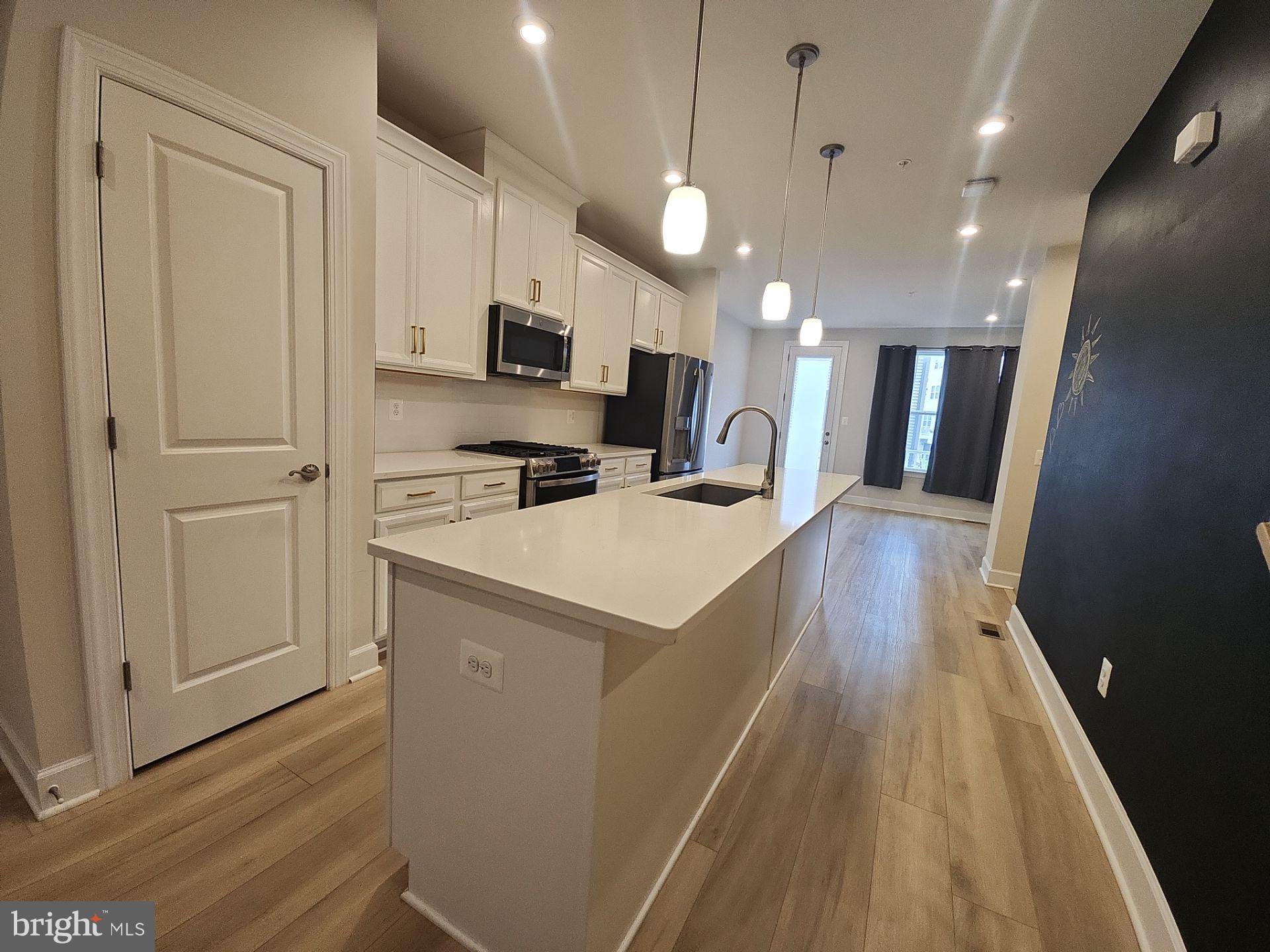 6730 Belcrest Road Hyattsville, MD 20782 - Photo 14 of 30 a view of a kitchen with cabinets and wooden floor
