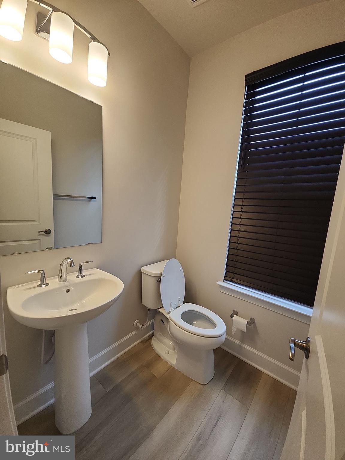 6730 Belcrest Road Hyattsville, MD 20782 - Photo 16 of 30 a bathroom with a sink toilet and mirror