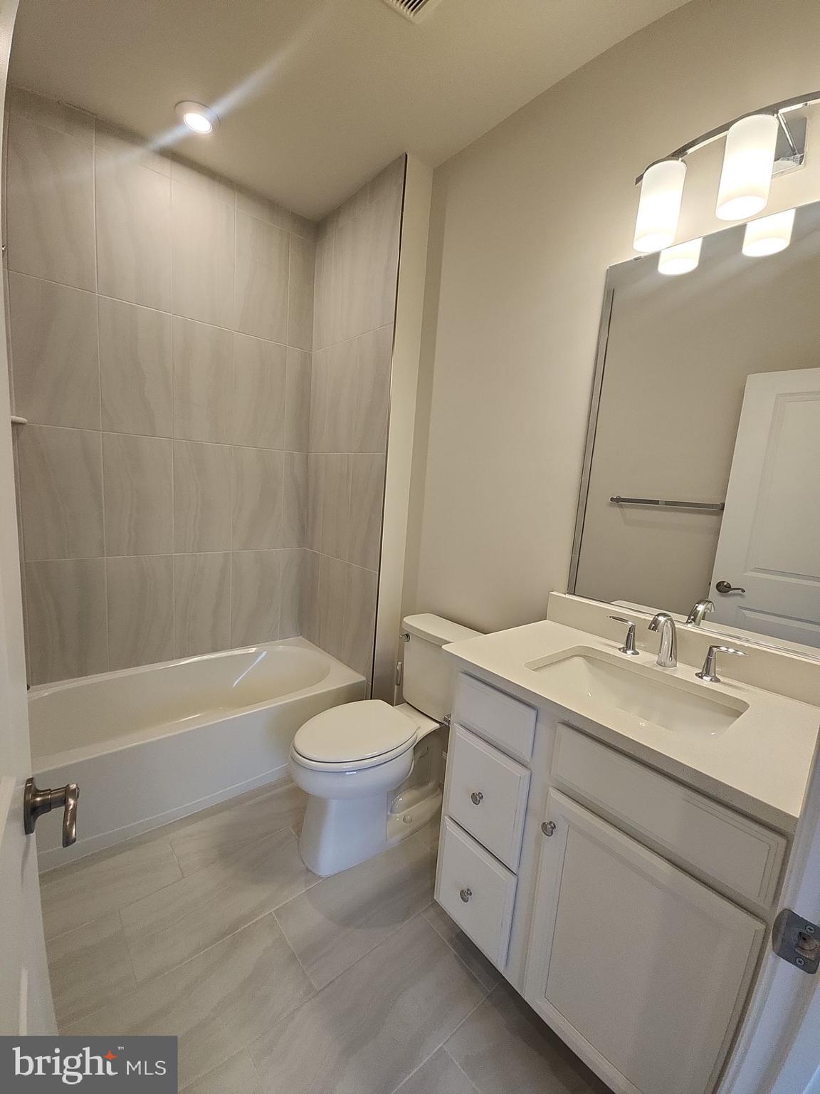 6730 Belcrest Road Hyattsville, MD 20782 - Photo 22 of 30 a bathroom with a double vanity sink toilet mirror and bathtub