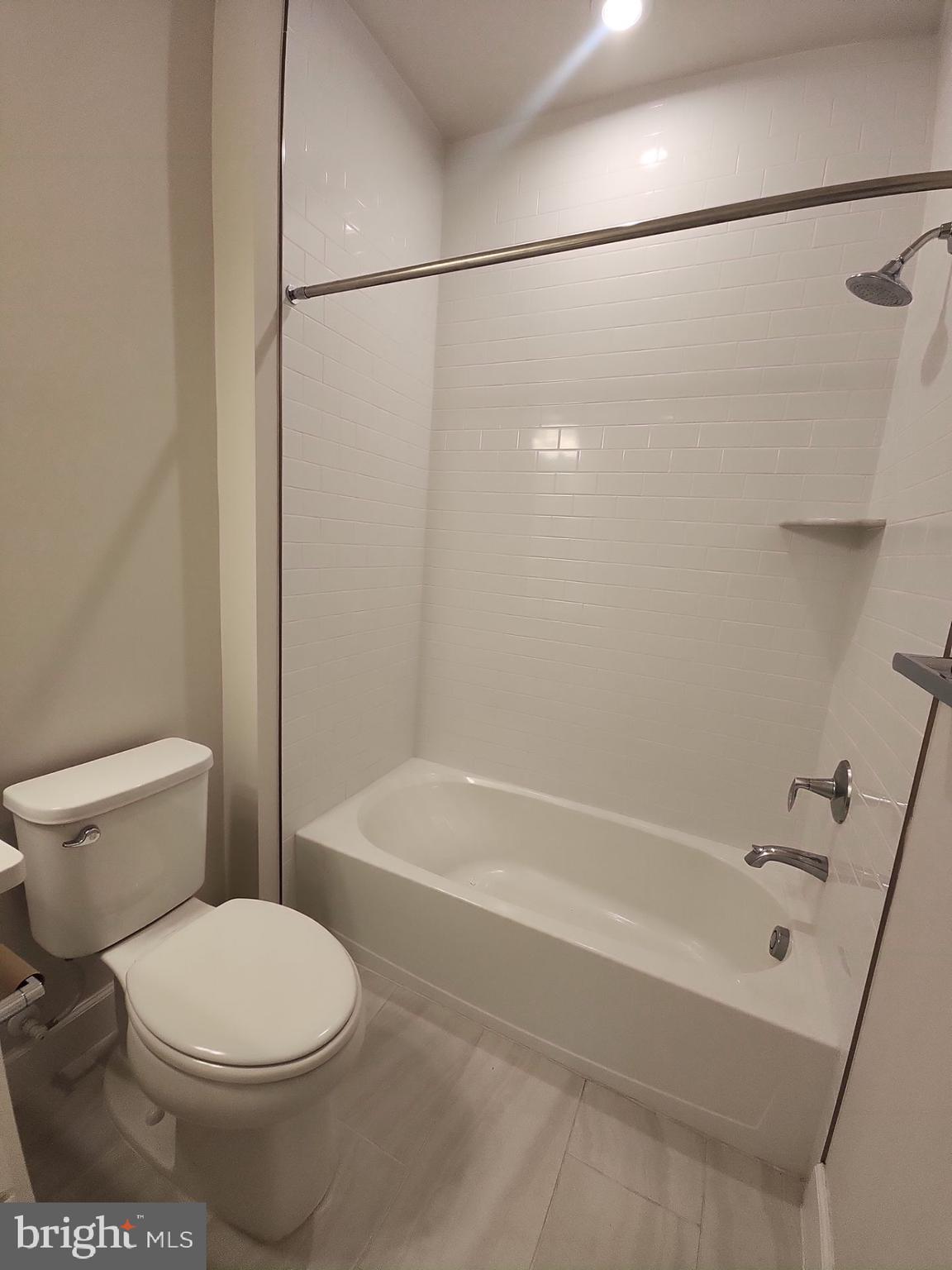 6730 Belcrest Road Hyattsville, MD 20782 - Photo 25 of 30 a bathroom with a toilet and a bathtub