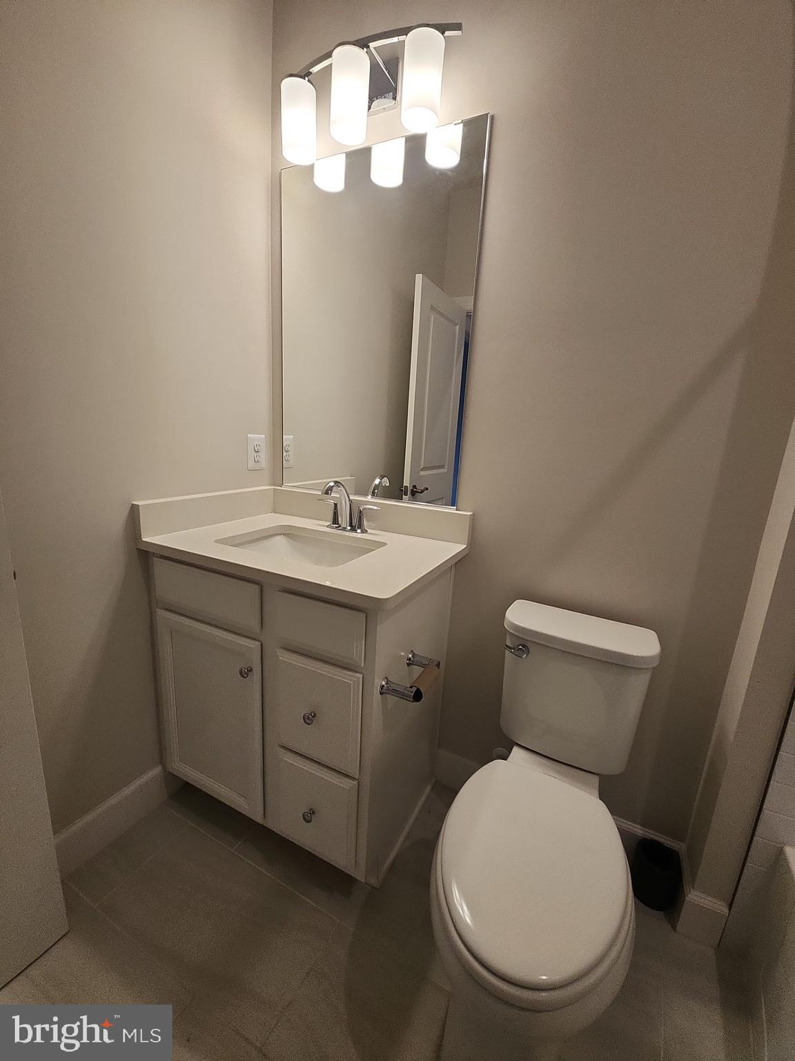 6730 Belcrest Road Hyattsville, MD 20782 - Photo 26 of 30 a bathroom with a toilet sink and mirror