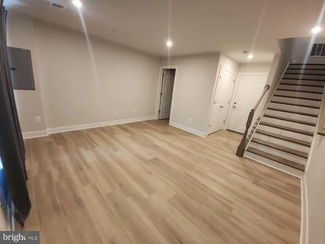 a view of an entryway with wooden floor