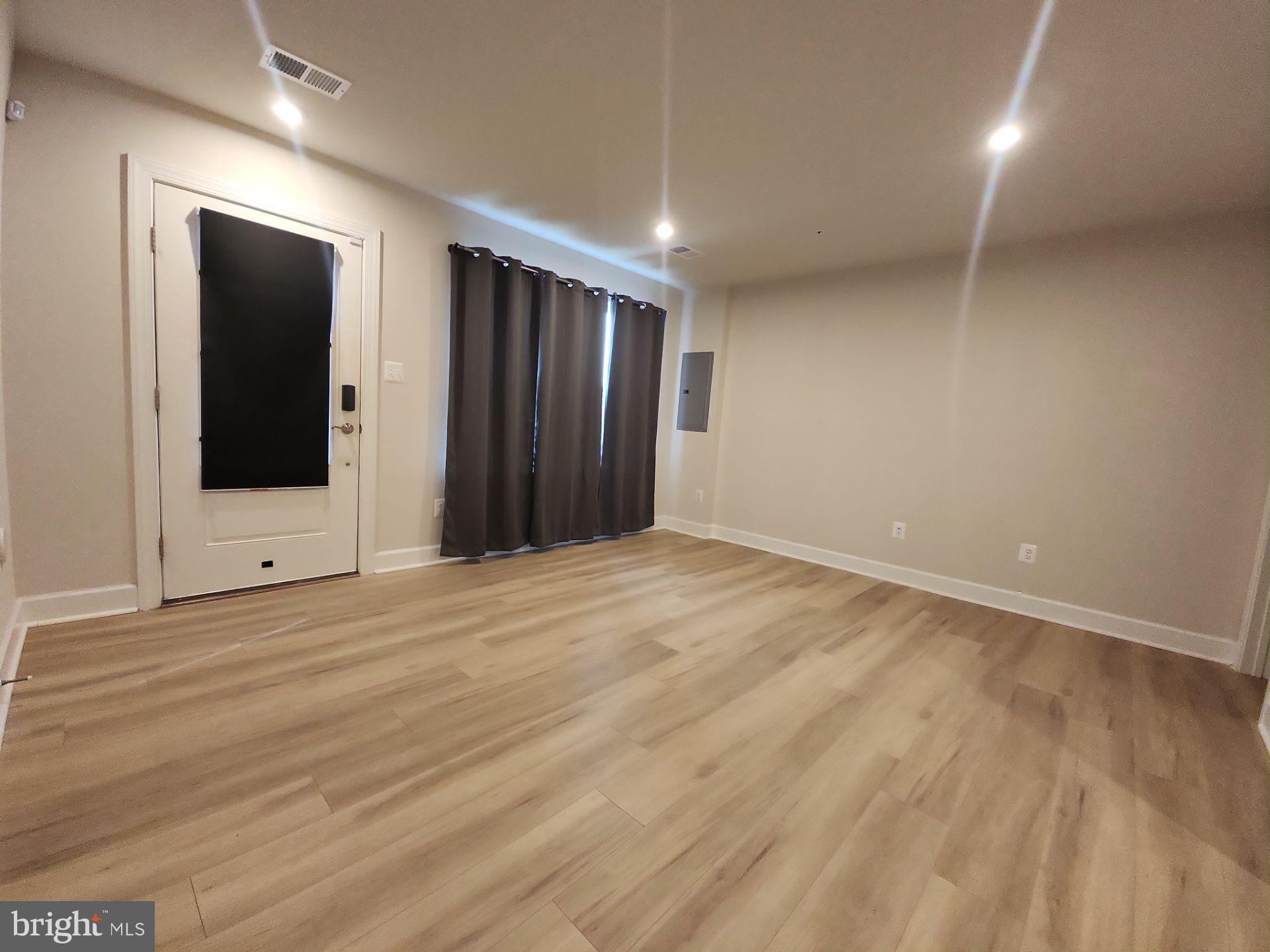6730 Belcrest Road Hyattsville, MD 20782 - Photo 4 of 30 an empty room with wooden floor and windows
