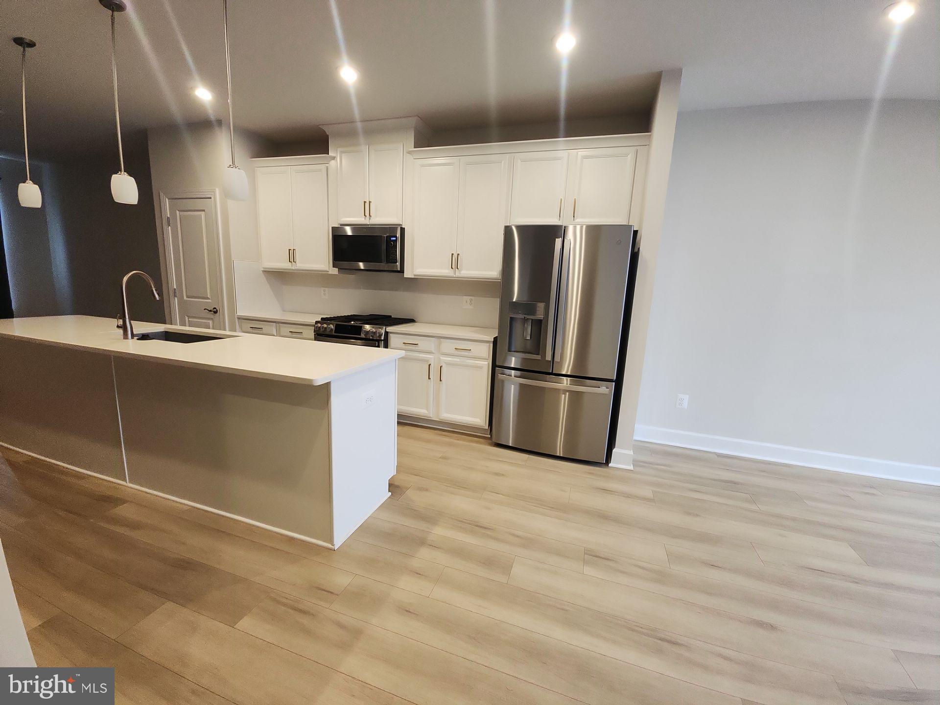 6730 Belcrest Road Hyattsville, MD 20782 - Photo 10 of 30 a kitchen with stainless steel appliances granite countertop a refrigerator a sink and a stove