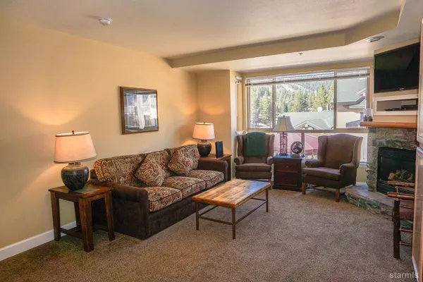 a bedroom with a bed furniture and a refrigerator