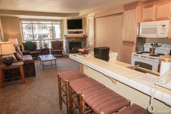 a living room with furniture and a dining table