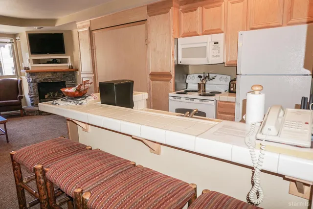 a living room with furniture and a dining table