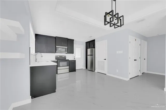 a kitchen with stainless steel appliances a refrigerator sink and cabinets