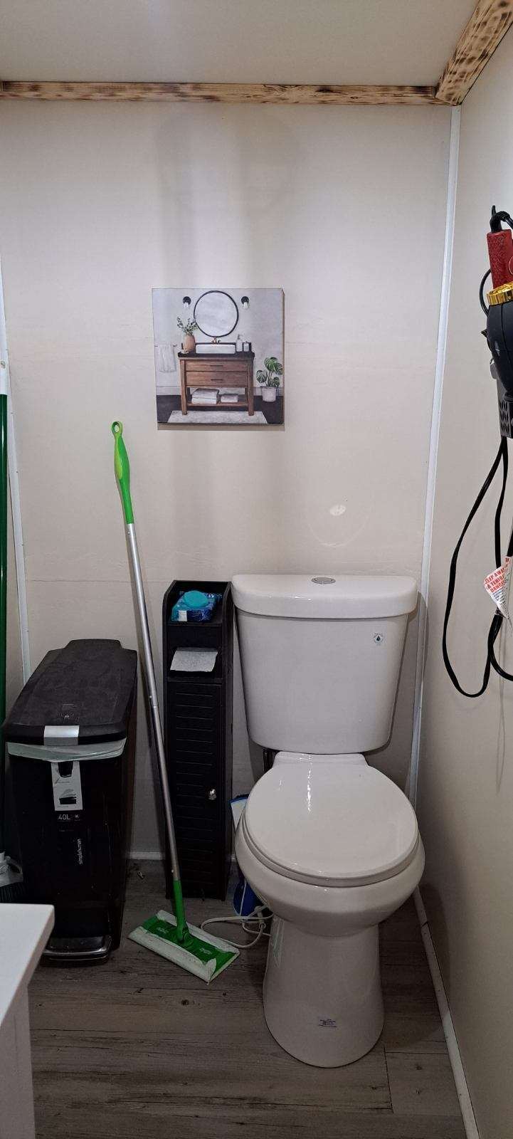 378 Sanders Road Decherd, TN 37324 - Photo 23 of 27 a white toilet sitting next to a bathroom sink and vanity