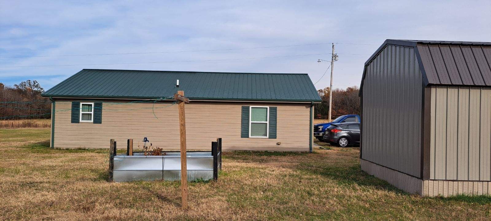 378 Sanders Road Decherd, TN 37324 - Photo 3 of 27 a backyard of a house with barbeque oven and outdoor seating