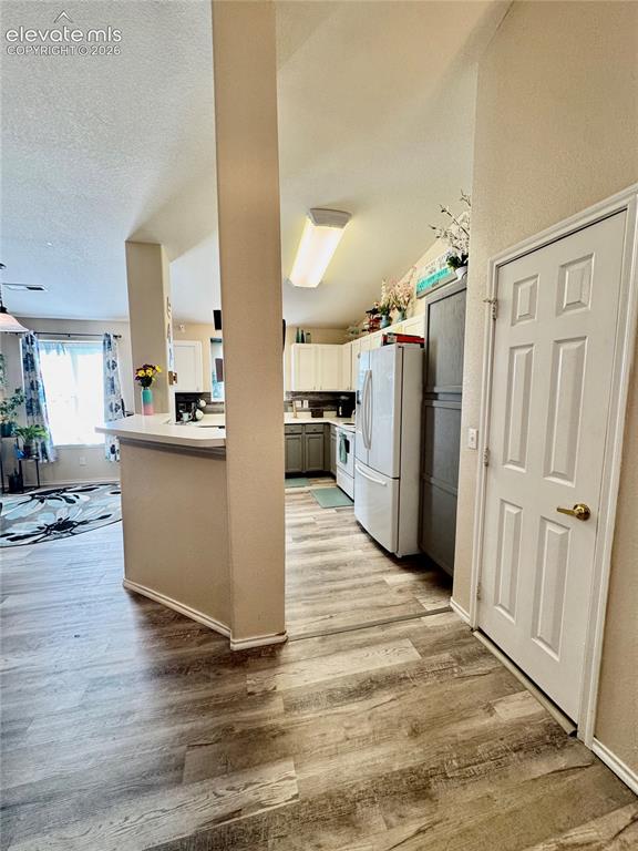 3748 Riviera Grove, Unit 203 Colorado Springs, CO 80922 - Photo 4 of 23 a view of a kitchen with wooden floor and a window