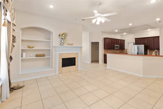 a kitchen with stainless steel appliances kitchen island granite countertop a refrigerator a stove a sink with a dining table and chairs