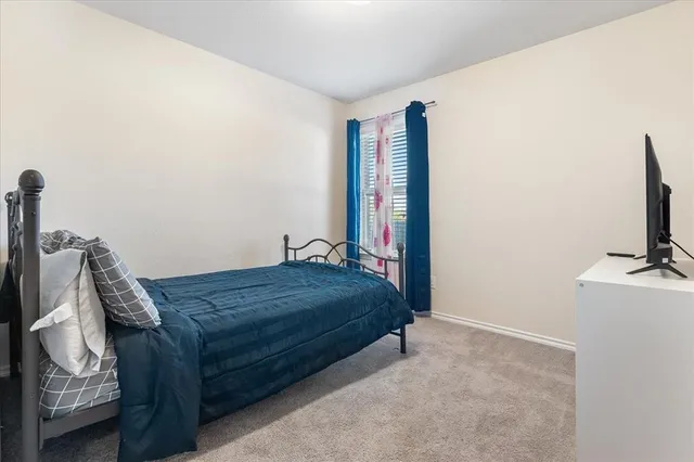 a bedroom with two beds and a dresser