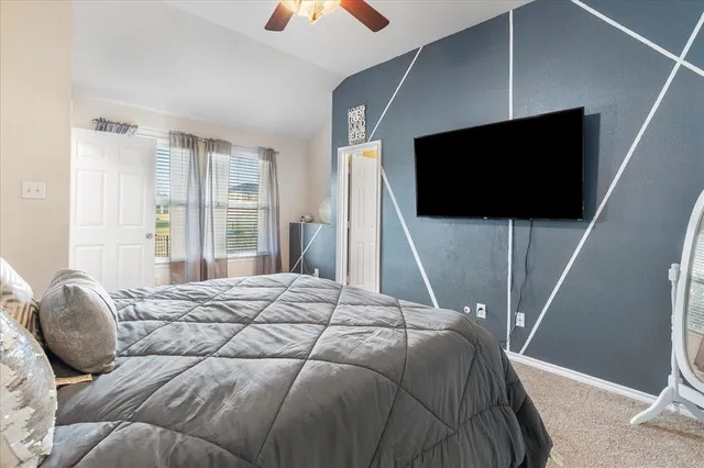 a bedroom with a bed and a flat screen tv