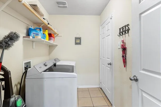 a view of walk in closet with clothes