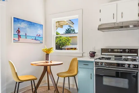 a view of a dining room with furniture and a potted plant