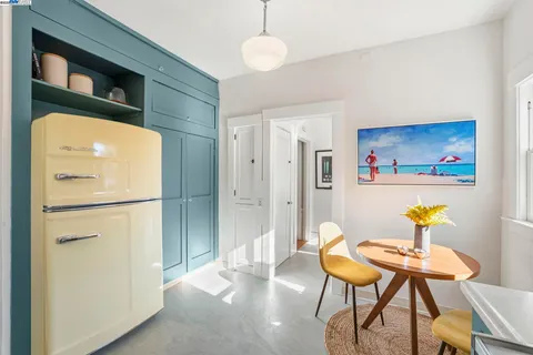 a kitchen with stainless steel appliances granite countertop a refrigerator a stove a sink and a white cabinets