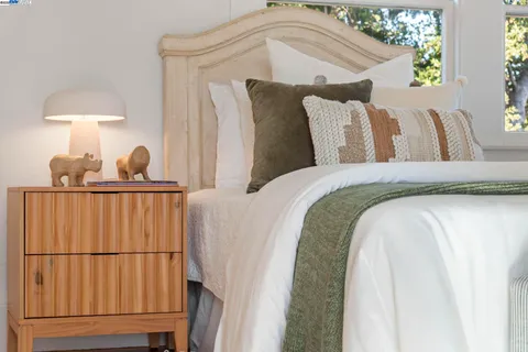 a view of a porch with potted plants and floor to ceiling window