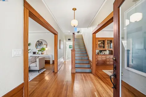 a view of entryway and hall with wooden floor