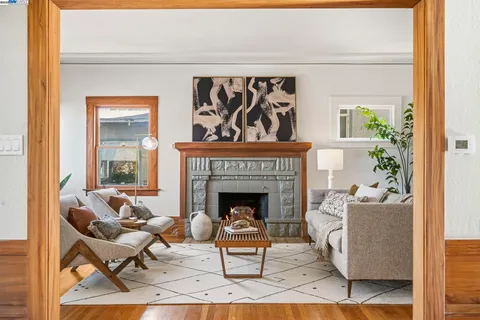 a living room with furniture a fireplace and a large window