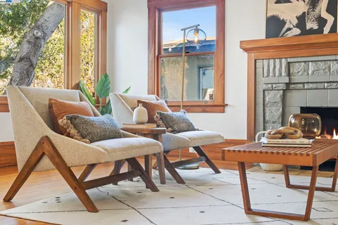 a living room with fireplace furniture and a large window