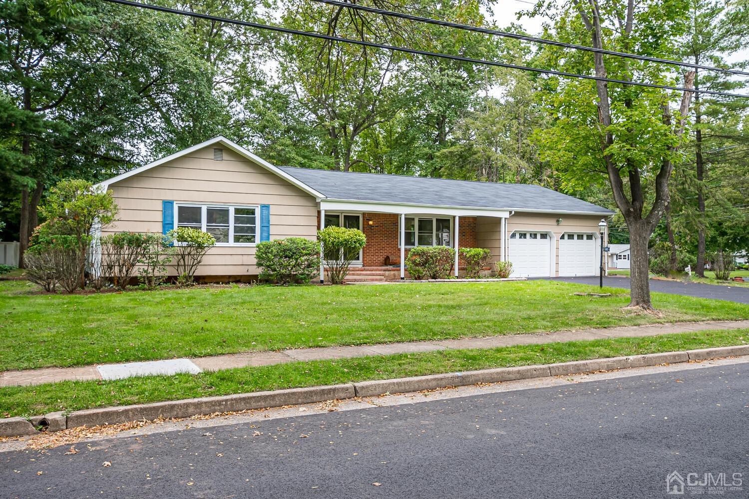 1 Lynnwood Road Edison, NJ 08820 - Photo 2 of 41 a front view of a house with a yard and trees