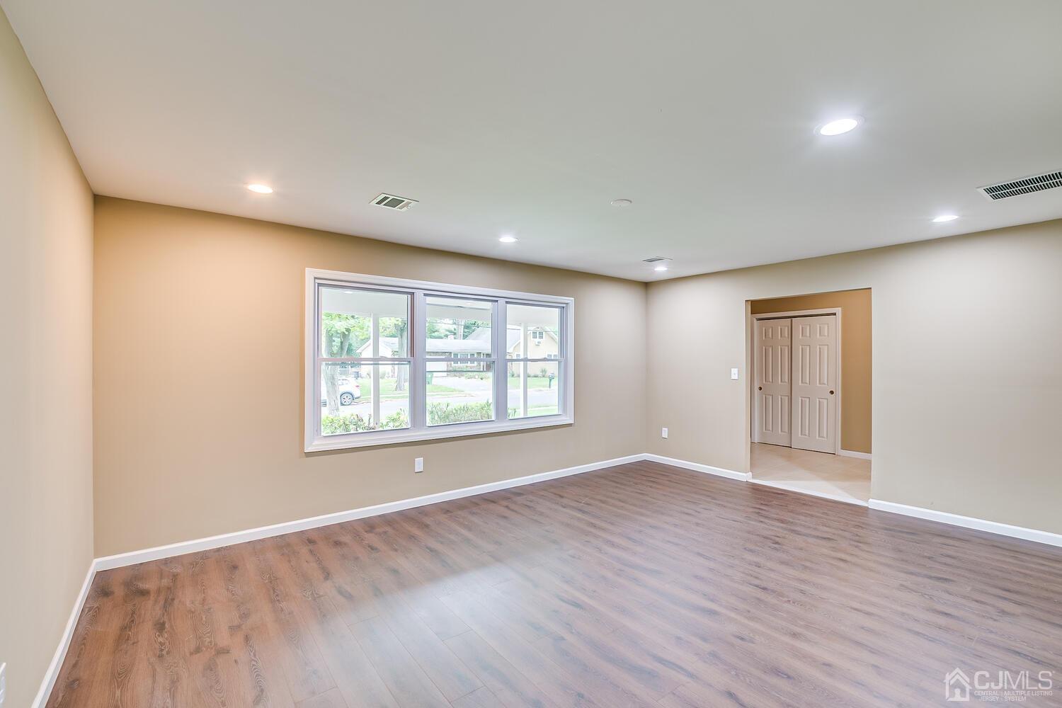 1 Lynnwood Road Edison, NJ 08820 - Photo 11 of 41 a view of an empty room with wooden floor and a window