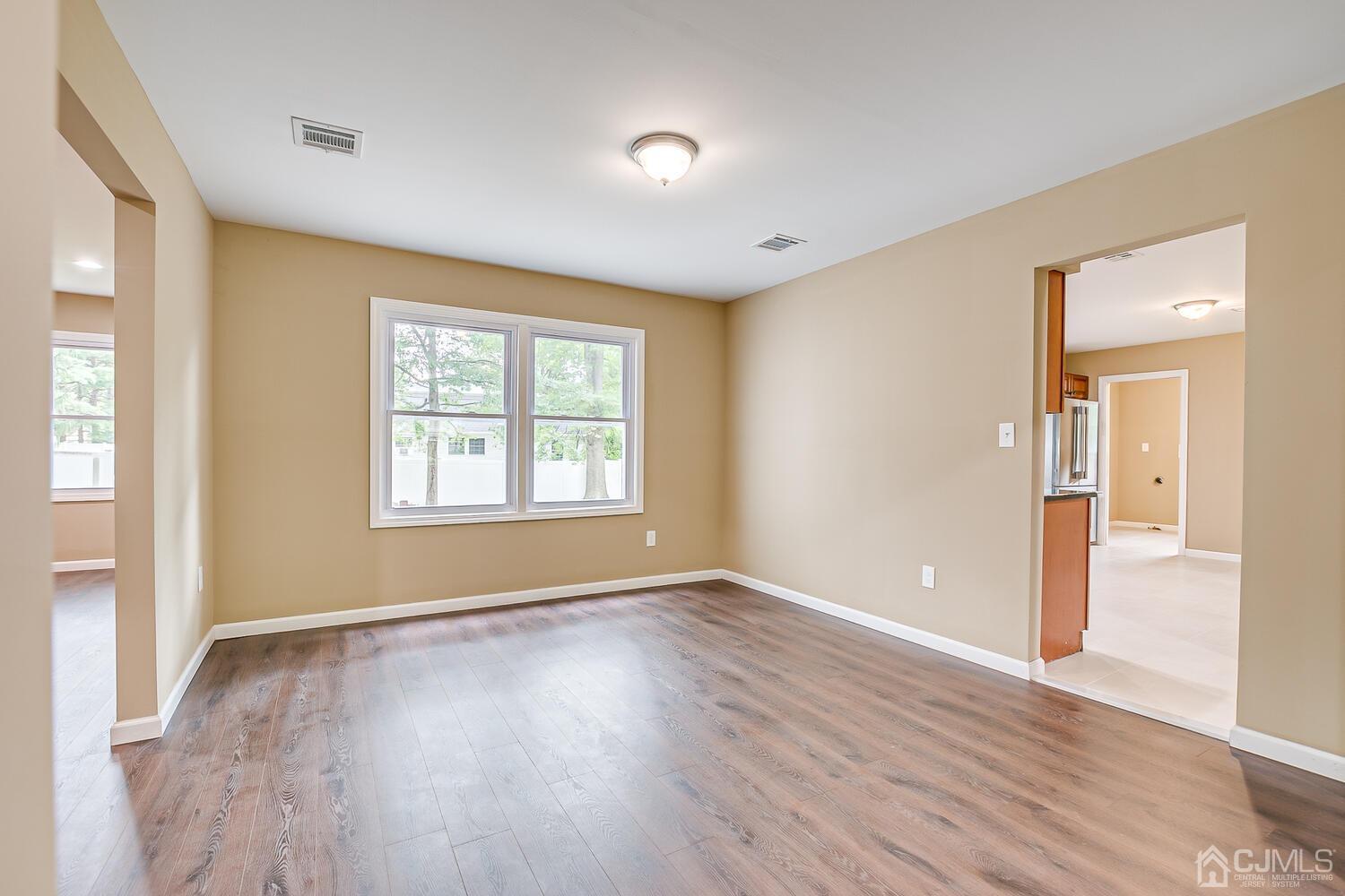 1 Lynnwood Road Edison, NJ 08820 - Photo 14 of 41 a view of an empty room with wooden floor and a window