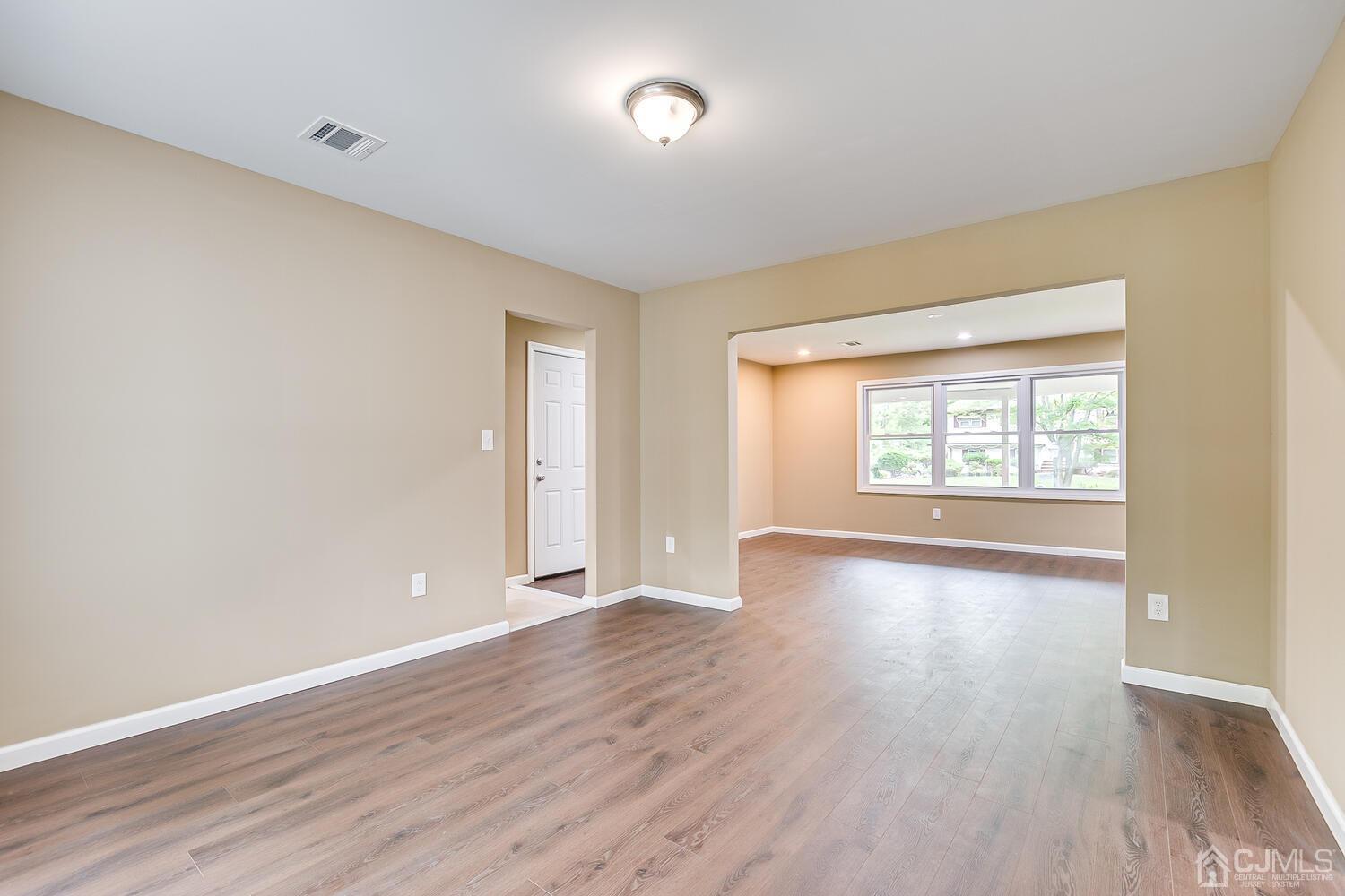 1 Lynnwood Road Edison, NJ 08820 - Photo 16 of 41 a view of an empty room with wooden floor and a window