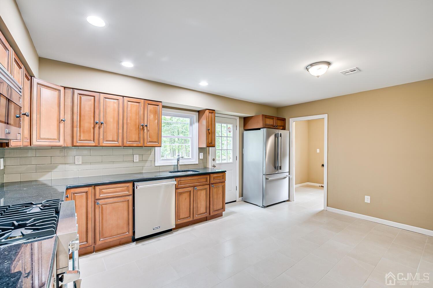 1 Lynnwood Road Edison, NJ 08820 - Photo 17 of 41 a large kitchen with stainless steel appliances granite countertop a refrigerator and a sink