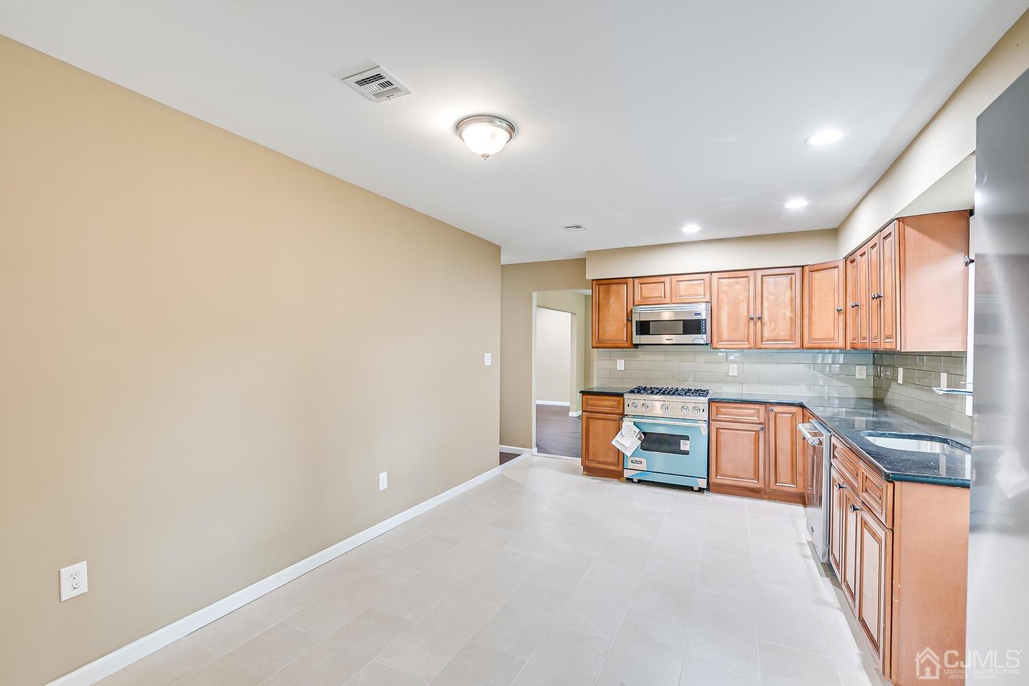 1 Lynnwood Road Edison, NJ 08820 - Photo 20 of 41 a kitchen with stainless steel appliances a refrigerator and a stove top oven