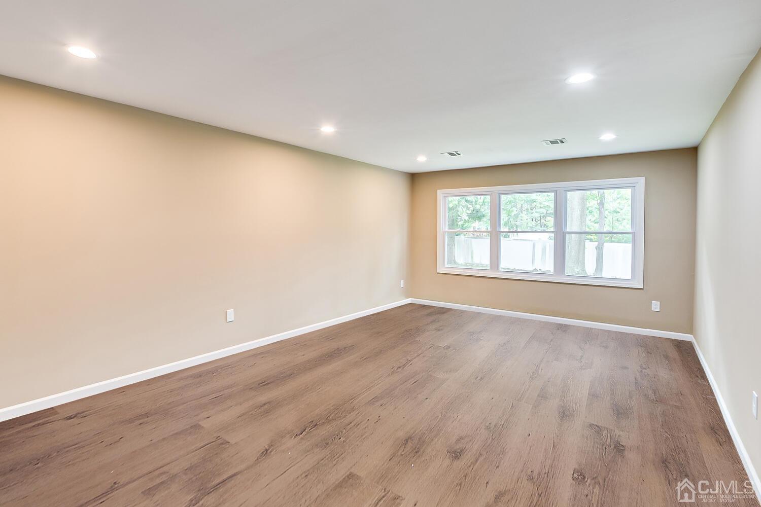 1 Lynnwood Road Edison, NJ 08820 - Photo 24 of 41 an empty room with wooden floor and windows