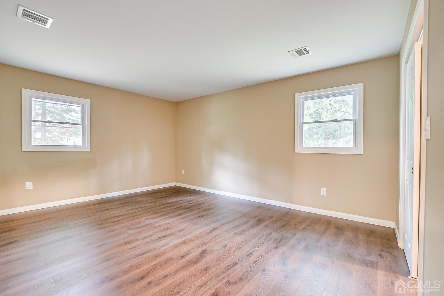 1 Lynnwood Road Edison, NJ 08820 - Photo 29 of 41 a view of an empty room with wooden floor and a window