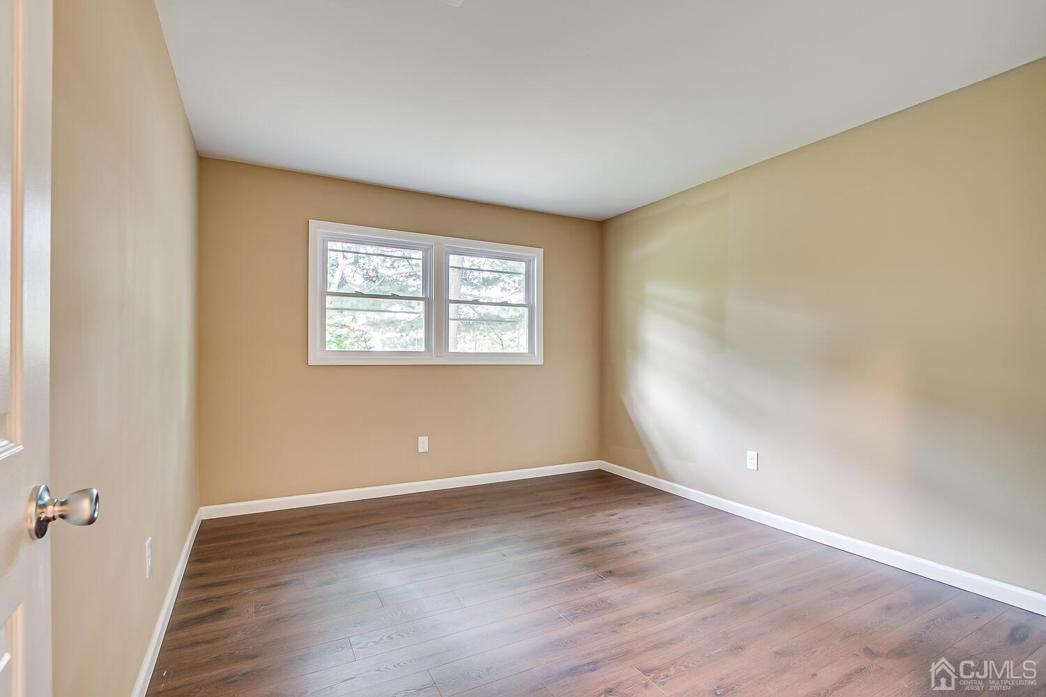 1 Lynnwood Road Edison, NJ 08820 - Photo 34 of 41 a view of an empty room with wooden floor and a window