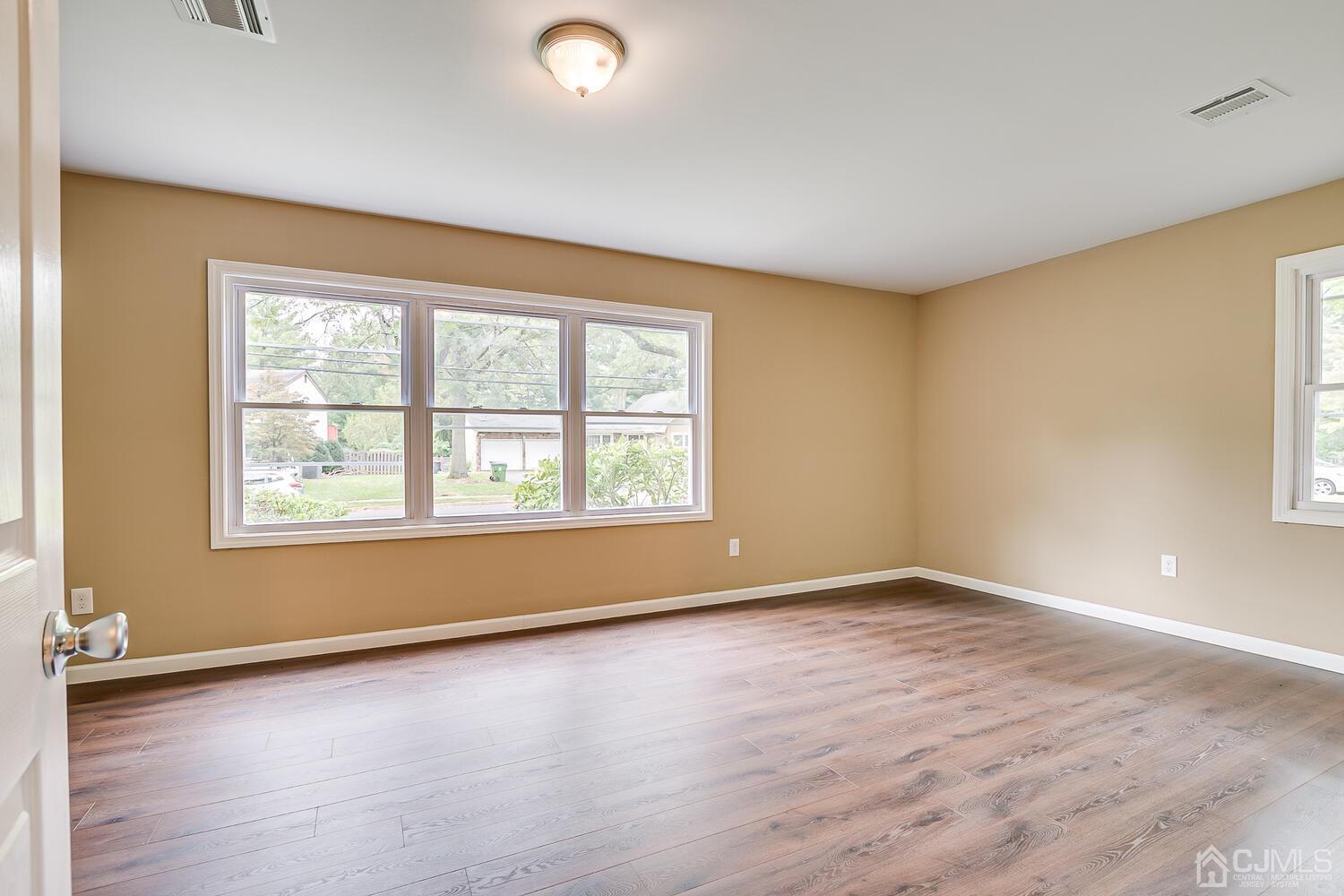 1 Lynnwood Road Edison, NJ 08820 - Photo 35 of 41 an empty room with wooden floor and windows