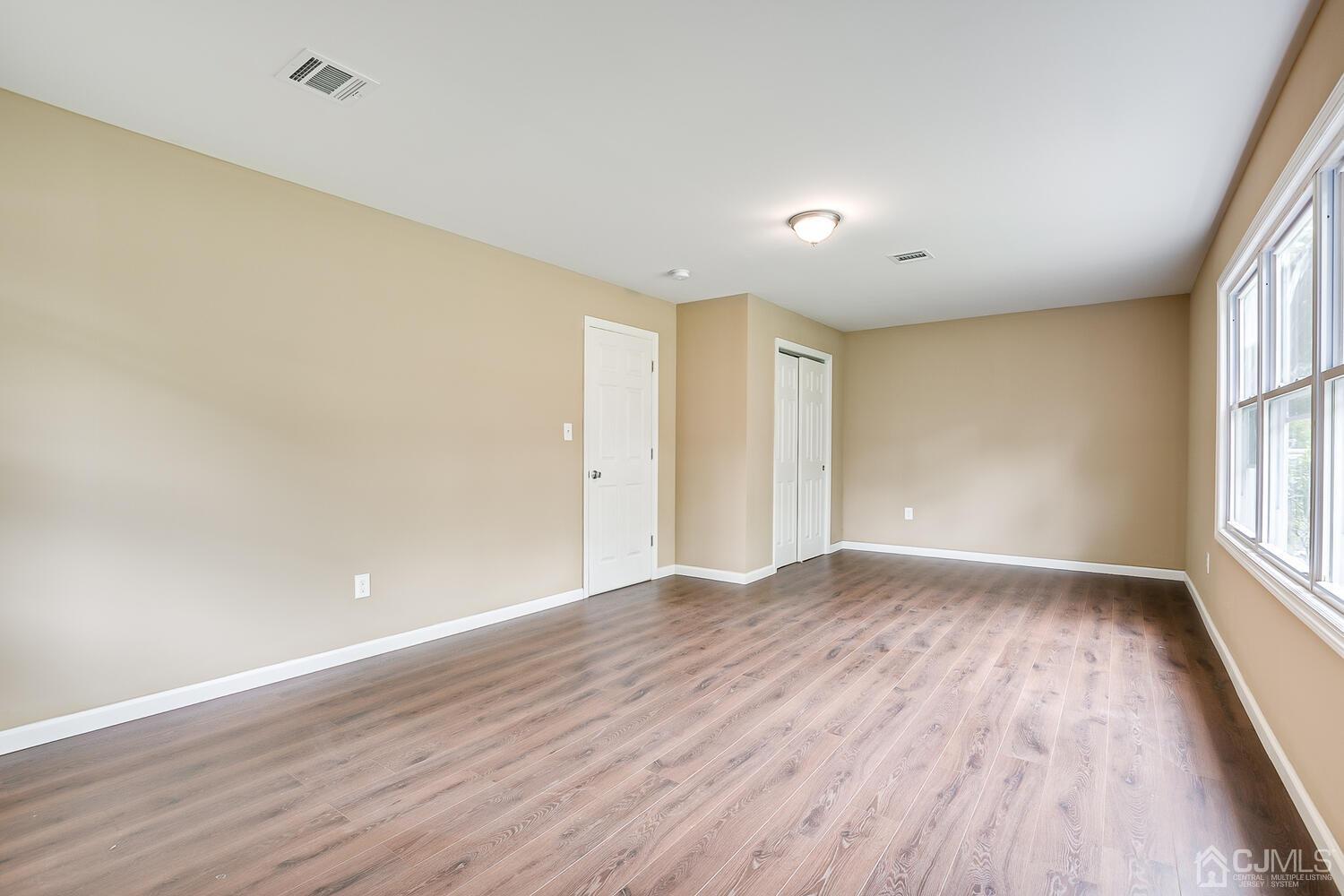1 Lynnwood Road Edison, NJ 08820 - Photo 36 of 41 a view of an empty room with wooden floor and a window